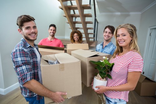 Preparing boxes and furniture for a move in a Deptford flat or house