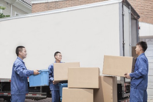 Furniture removal team handling a sofa move in Deptford