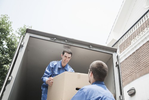 Local removal team handling boxes and furniture near Deptford